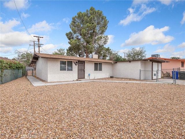 15533 Heartsease Ln, Victorville, CA 92395 - view of front of home featuring a gate, stucco siding, and fence