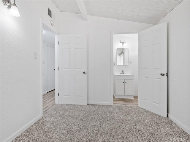 15533 Heartsease Ln, Victorville, CA 92395 - unfurnished bedroom with light carpet, a sink, baseboards, and beamed ceiling