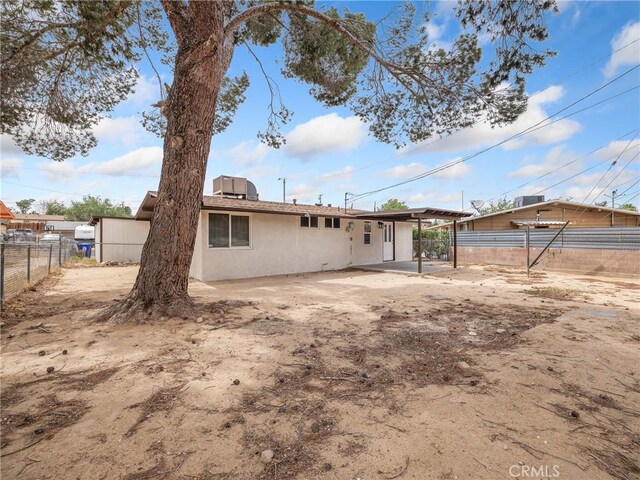 15533 Heartsease Ln, Victorville, CA 92395 - rear view of house with fence, stucco siding, and a patio area