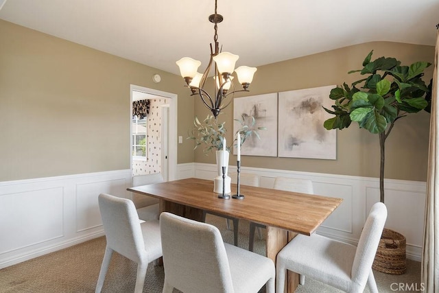 14691 Leon Pl, Tustin, CA 92780 - dining area featuring a chandelier, wainscoting, a decorative wall, and carpet flooring