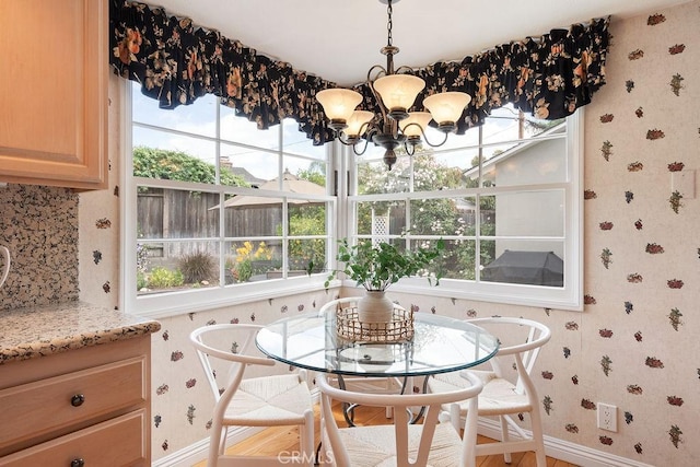 14691 Leon Pl, Tustin, CA 92780 - dining space with wallpapered walls, a chandelier, and baseboards