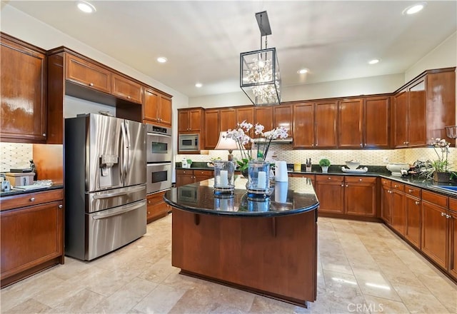 16418 Village Meadow Dr, Riverside, CA 92503 - kitchen with appliances with stainless steel finishes, decorative backsplash, a kitchen island, dark stone countertops, and recessed lighting