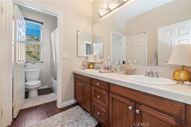16418 Village Meadow Dr, Riverside, CA 92503 - full bath with toilet, double vanity, wood finished floors, baseboards, and shower / bathtub combination with curtain