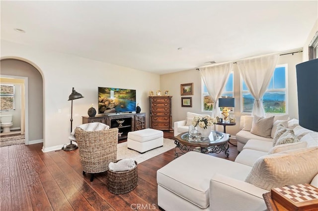 16418 Village Meadow Dr, Riverside, CA 92503 - living area with dark wood-style flooring, arched walkways, and baseboards