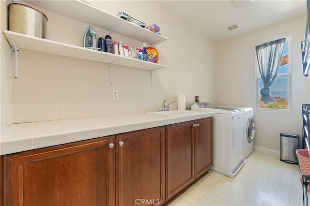 16418 Village Meadow Dr, Riverside, CA 92503 - washroom featuring cabinet space, washer and clothes dryer, and baseboards