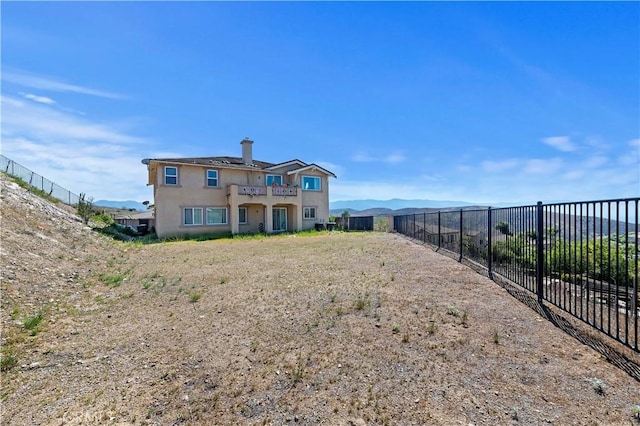 16418 Village Meadow Dr, Riverside, CA 92503 - back of house with fence, stucco siding, and a balcony
