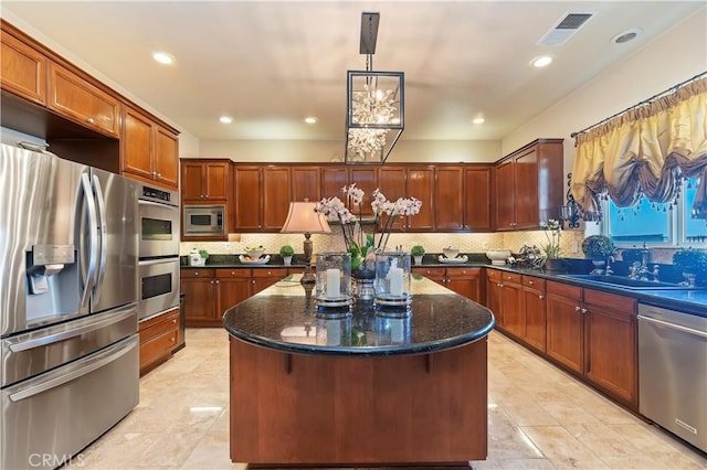 16418 Village Meadow Dr, Riverside, CA 92503 - kitchen with appliances with stainless steel finishes, a sink, a kitchen island, decorative backsplash, and recessed lighting