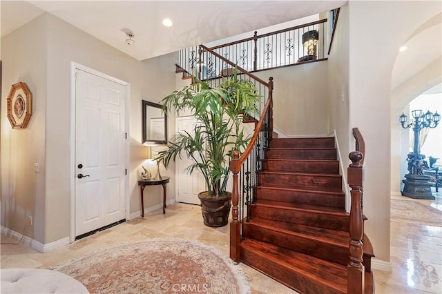 16418 Village Meadow Dr, Riverside, CA 92503 - foyer entrance featuring arched walkways, stairway, baseboards, recessed lighting, and marble tiled floors