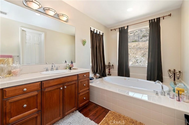 16418 Village Meadow Dr, Riverside, CA 92503 - bathroom featuring wood finished floors, a garden tub, and vanity