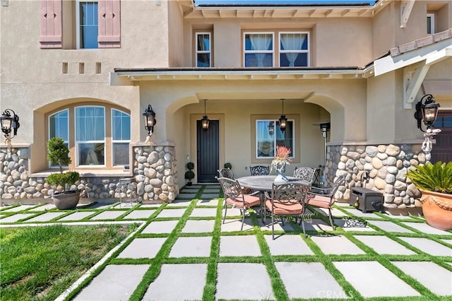 16418 Village Meadow Dr, Riverside, CA 92503 - back of property featuring stucco siding, a patio, stone siding, and outdoor dining area