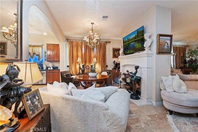16418 Village Meadow Dr, Riverside, CA 92503 - living area featuring a chandelier, light stone finish flooring, a lit fireplace, baseboards, and arched walkways