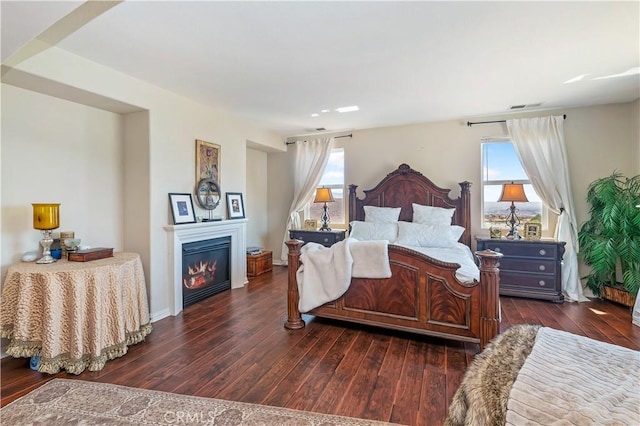 16418 Village Meadow Dr, Riverside, CA 92503 - bedroom featuring hardwood / wood-style flooring, a glass covered fireplace, and baseboards