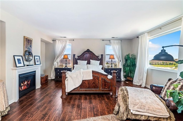 16418 Village Meadow Dr, Riverside, CA 92503 - bedroom with wood-type flooring and a glass covered fireplace