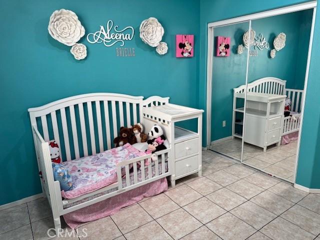 1421 Alta Palma Rd, Perris, CA 92571 - bedroom with tile patterned flooring, a closet, and baseboards