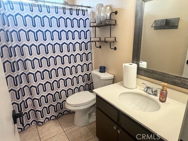 1421 Alta Palma Rd, Perris, CA 92571 - full bath with toilet, tile patterned floors, vanity, and curtained shower