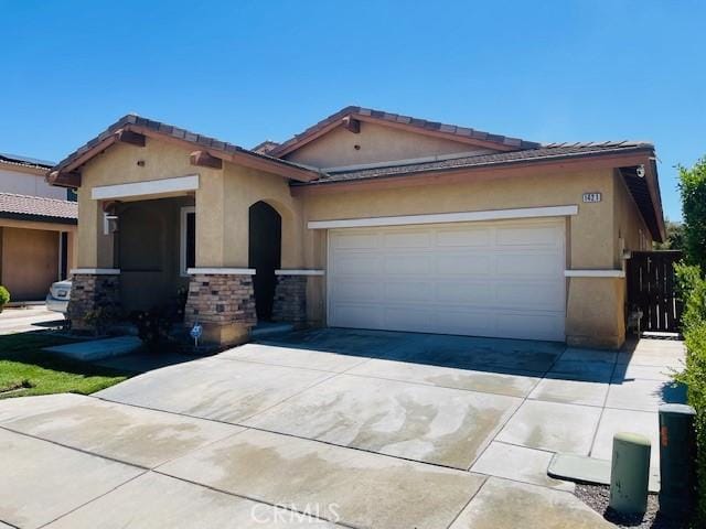 1421 Alta Palma Rd, Perris, CA 92571 - ranch-style house featuring stucco siding, concrete driveway, an attached garage, and stone siding
