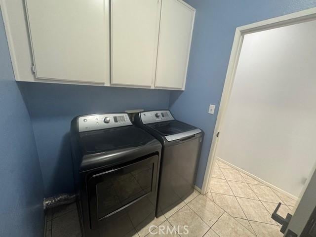 1421 Alta Palma Rd, Perris, CA 92571 - laundry area with washing machine and dryer, cabinet space, light tile patterned floors, and baseboards