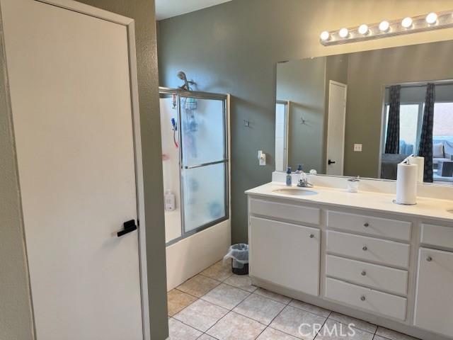 1421 Alta Palma Rd, Perris, CA 92571 - full bath featuring tile patterned floors, double vanity, and shower / bath combination with glass door
