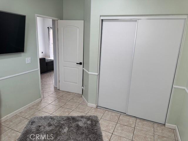 1421 Alta Palma Rd, Perris, CA 92571 - unfurnished bedroom with light tile patterned floors, a closet, and baseboards