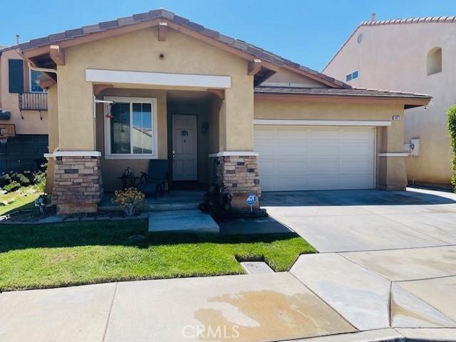 1421 Alta Palma Rd, Perris, CA 92571 - view of front of property with concrete driveway, a garage, stucco siding, and stone siding