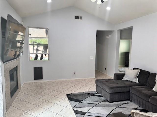 1421 Alta Palma Rd, Perris, CA 92571 - living room with vaulted ceiling, light tile patterned flooring, and a glass covered fireplace