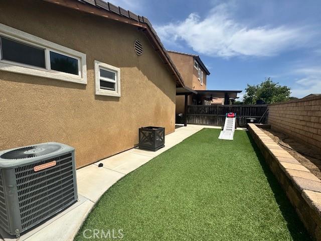 1421 Alta Palma Rd, Perris, CA 92571 - view of yard featuring central AC and a patio area