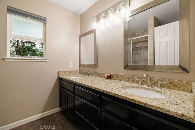 3171 Eagle Lake Ct, Chico, CA 95973 - full bathroom featuring tiled shower, tile patterned floors, double vanity, and baseboards