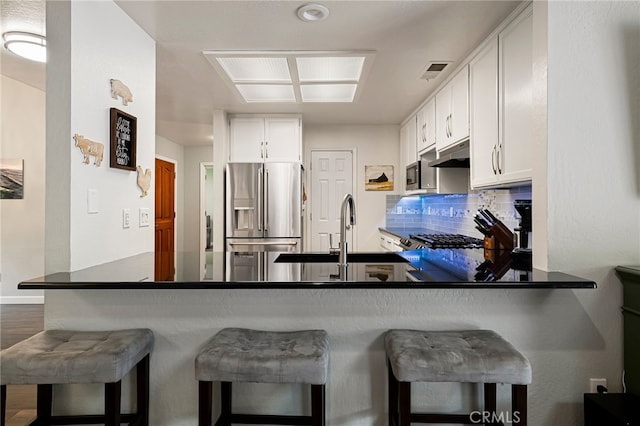 3171 Eagle Lake Ct, Chico, CA 95973 - kitchen featuring appliances with stainless steel finishes, under cabinet range hood, a sink, and white cabinets