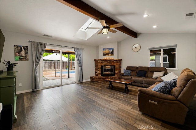 3171 Eagle Lake Ct, Chico, CA 95973 - living room with ceiling fan, a skylight, dark wood-style flooring, a brick fireplace, and recessed lighting