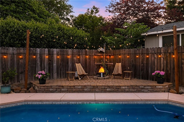 3171 Eagle Lake Ct, Chico, CA 95973 - pool at dusk featuring a fire pit and a patio area