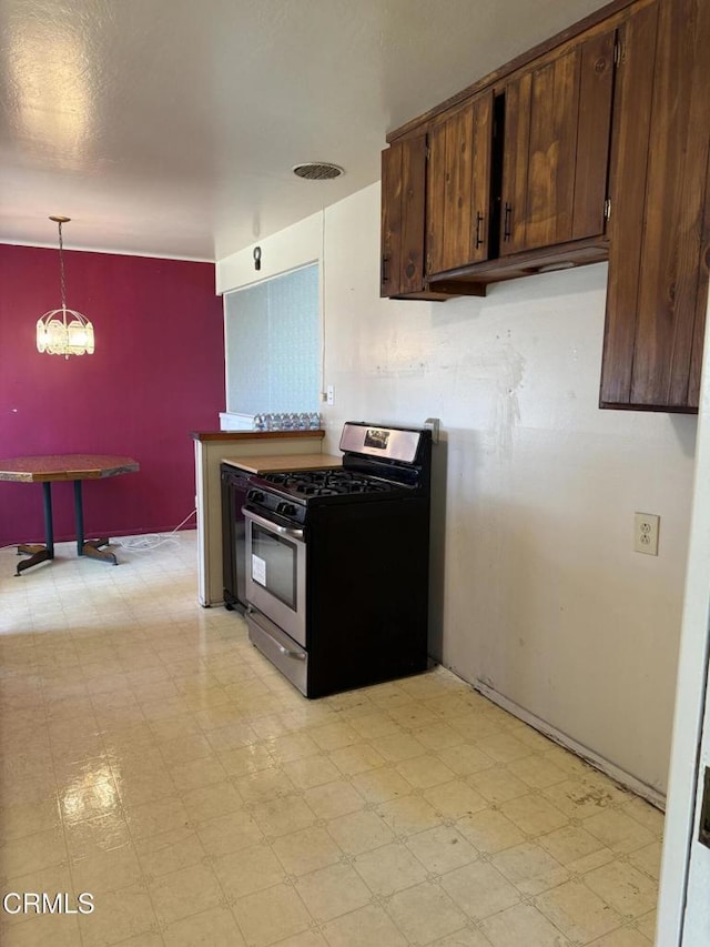 4117 S C St, Oxnard, CA 93033 - kitchen with gas range, dark brown cabinets, and light flooring