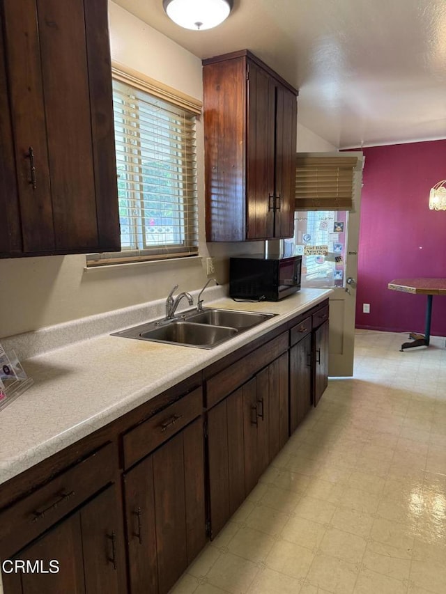 4117 S C St, Oxnard, CA 93033 - kitchen featuring black microwave, light flooring, light countertops, and dark brown cabinetry