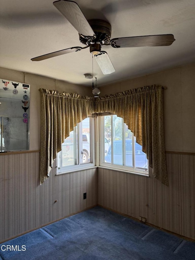 4117 S C St, Oxnard, CA 93033 - spare room with carpet, ceiling fan, wooden walls, and wainscoting