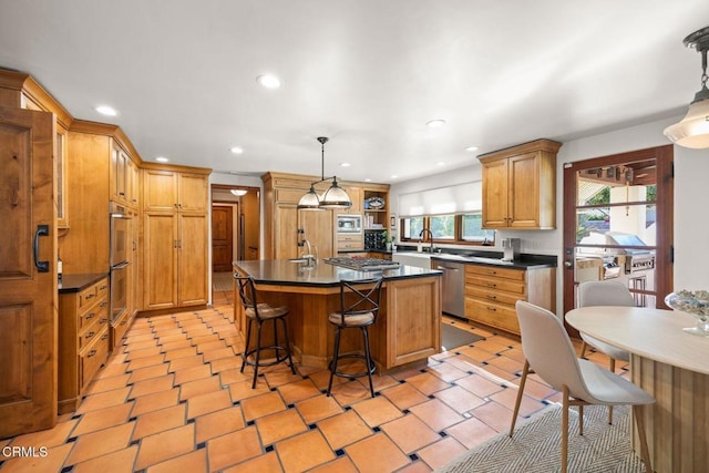 10971 Alto Ct, Oak View, CA 93022 - kitchen with dark countertops, a sink, stainless steel appliances, a kitchen island, and recessed lighting