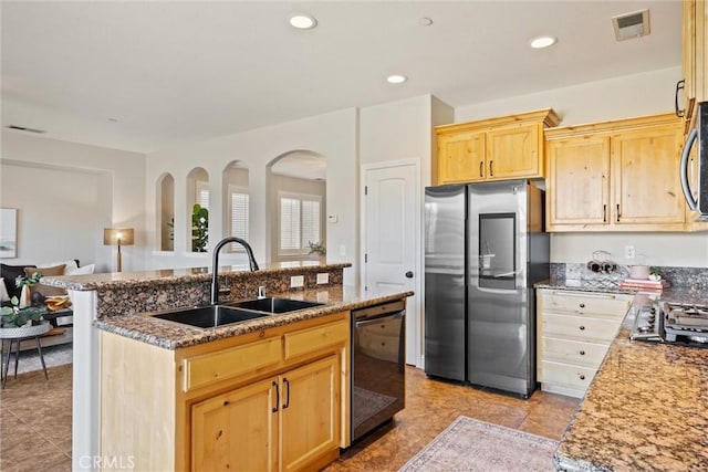 7 Abbott Cir, Chico, CA 95973 - kitchen featuring a sink, appliances with stainless steel finishes, light brown cabinetry, a center island with sink, and arched walkways