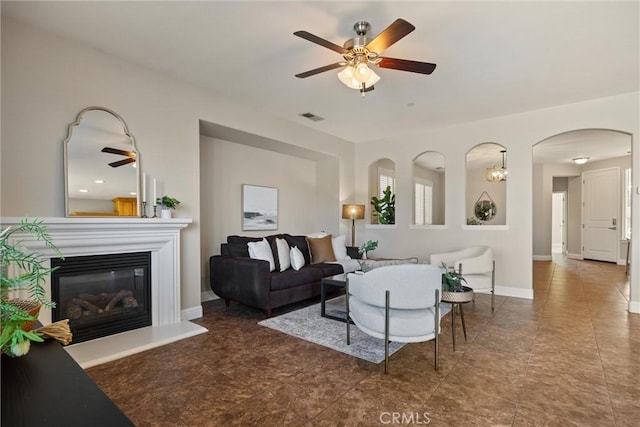 7 Abbott Cir, Chico, CA 95973 - living room featuring ceiling fan, arched walkways, a glass covered fireplace, and baseboards