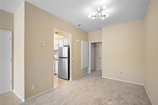 777 S Citrus Ave Unit 266, Azusa, CA 91702 - unfurnished bedroom featuring freestanding refrigerator, baseboards, light carpet, and a chandelier