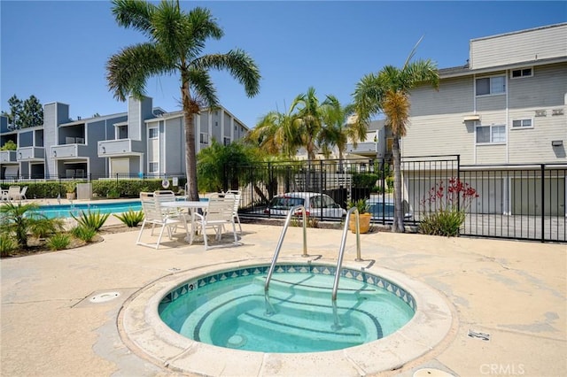 777 S Citrus Ave Unit 266, Azusa, CA 91702 - view of pool with fence, a community hot tub, a residential view, and a patio