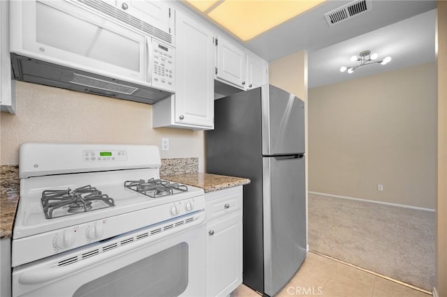 777 S Citrus Ave Unit 266, Azusa, CA 91702 - kitchen with white appliances, light colored carpet, white cabinets, baseboards, and light tile patterned floors