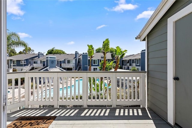 balcony featuring a residential view and view of pool
