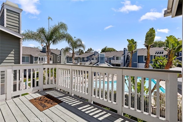 deck with a residential view and a community pool