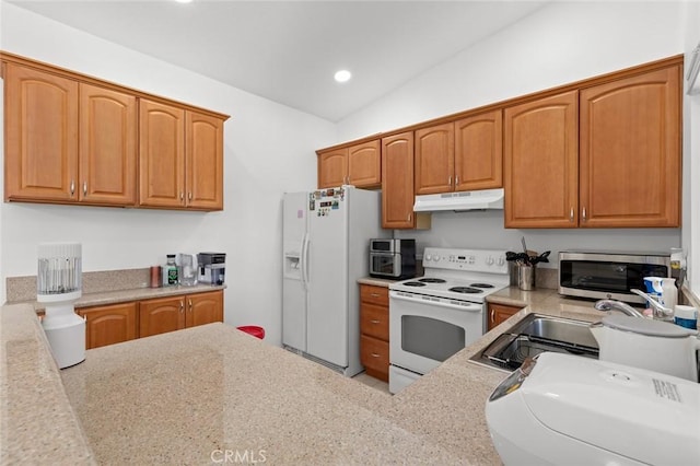 kitchen with white appliances, under cabinet range hood, a sink, recessed lighting, and lofted ceiling