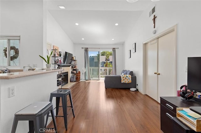 living area with wood finished floors and recessed lighting