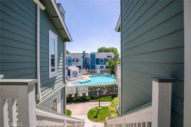 community pool with fence and a patio