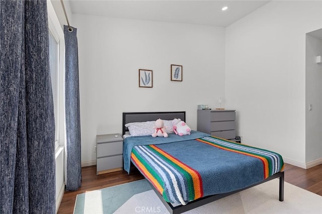 bedroom featuring wood finished floors, baseboards, and recessed lighting