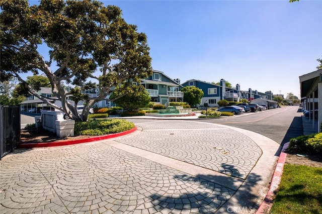 view of street featuring a residential view and curbs