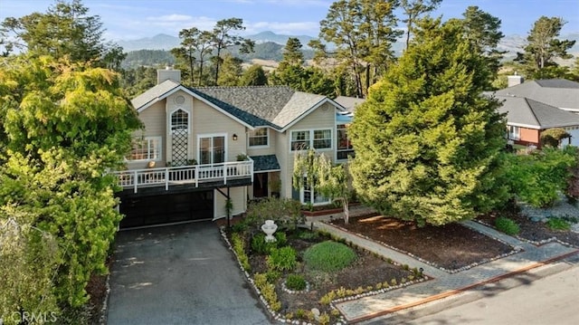 3061 Wood Dr, Cambria, CA 93428 - view of front of house featuring asphalt driveway, a mountain view, and a chimney