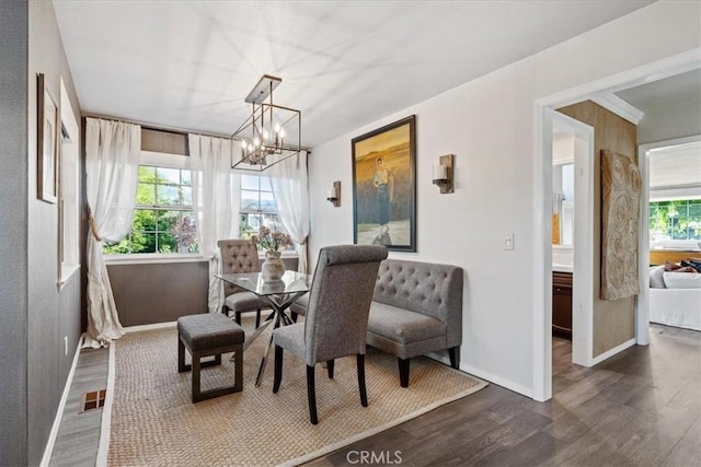 3061 Wood Dr, Cambria, CA 93428 - dining area featuring dark wood-style floors, baseboards, and a chandelier