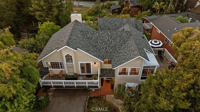 3061 Wood Dr, Cambria, CA 93428 - view of front facade featuring roof with shingles, a deck, and a chimney