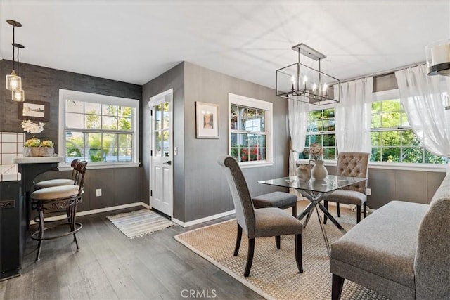 3061 Wood Dr, Cambria, CA 93428 - dining space with wood finished floors, baseboards, and a chandelier